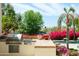 Outdoor kitchen with built-in grill and gorgeous desert landscaping near the pool at 10800 E Cactus Rd # 34, Scottsdale, AZ 85259