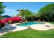 Backyard pool with lush landscaping and mature trees with lounge chairs at 10800 E Cactus Rd # 34, Scottsdale, AZ 85259