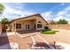 Well landscaped backyard with a putting green, covered patio and walkway to enjoy your outdoor living space at 12428 W Vermont Ct, Litchfield Park, AZ 85340