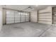 Spacious two car garage with built in shelving units, ready for your vehicles and storage needs at 12428 W Vermont Ct, Litchfield Park, AZ 85340