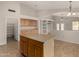 Open eat-in kitchen with access to the pantry and views to the living room and backyard at 12428 W Vermont Ct, Litchfield Park, AZ 85340