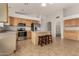 Bright eat-in kitchen featuring light wood cabinets, an island, and stainless steel appliances at 12428 W Vermont Ct, Litchfield Park, AZ 85340