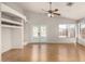 Bright living room with beautiful hardwood floors, a ceiling fan, and views of the backyard at 12428 W Vermont Ct, Litchfield Park, AZ 85340