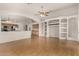Open-concept living area adjacent to the kitchen, featuring hardwood floors and built-in shelving at 12428 W Vermont Ct, Litchfield Park, AZ 85340