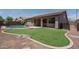 Grassy backyard featuring a pool and an outdoor grilling area at 12503 W Vista Paseo Dr, Litchfield Park, AZ 85340