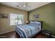 Bedroom with a window, ceiling fan, and wood floors at 12503 W Vista Paseo Dr, Litchfield Park, AZ 85340