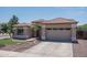 Inviting home with a tile roof, two-car garage, and meticulously landscaped front yard at 12503 W Vista Paseo Dr, Litchfield Park, AZ 85340