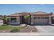 Charming single-story home with a well-manicured front yard and a two-car garage at 12503 W Vista Paseo Dr, Litchfield Park, AZ 85340