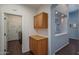 Hallway featuring cabinets with wood floors and an archway at 12503 W Vista Paseo Dr, Litchfield Park, AZ 85340