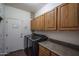 Convenient laundry room features a washer, dryer, and built-in cabinets with counter space at 12503 W Vista Paseo Dr, Litchfield Park, AZ 85340