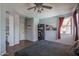 Bright main bedroom featuring dark wood floors, an ensuite bathroom, and a decorative bookshelf at 12503 W Vista Paseo Dr, Litchfield Park, AZ 85340