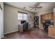 Home office with wood floors, a ceiling fan, and built-in shelving at 12503 W Vista Paseo Dr, Litchfield Park, AZ 85340