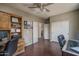 Office space with built-in cabinets, wood floors, and a printer at 12503 W Vista Paseo Dr, Litchfield Park, AZ 85340