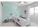 Bright bedroom features a twin-sized bed and mint-colored accent wall at 13270 N 93Rd Way, Scottsdale, AZ 85260