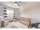 Bedroom room with crib, rocking chair, and decorated wall at 13270 N 93Rd Way, Scottsdale, AZ 85260