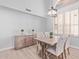 Bright dining room with a large window, a modern chandelier, and stylish neutral furniture at 13270 N 93Rd Way, Scottsdale, AZ 85260
