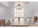 Dining room features high ceilings, a large window with shutters, and a wooden dining table at 13270 N 93Rd Way, Scottsdale, AZ 85260