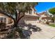 View of the home's side, featuring a long driveway, a three-car garage, and desert landscaping at 13270 N 93Rd Way, Scottsdale, AZ 85260