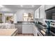 Bright eat-in kitchen featuring modern appliances, granite countertops, and backyard views at 13270 N 93Rd Way, Scottsdale, AZ 85260