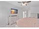 Bright bedroom features a king-sized bed and media on the wall at 13270 N 93Rd Way, Scottsdale, AZ 85260