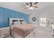 Bright bedroom features a queen-sized bed, blue accent wall, and arched window at 13270 N 93Rd Way, Scottsdale, AZ 85260