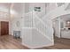Elegant staircase with white railings and wood floors, leading to an open living area at 13270 N 93Rd Way, Scottsdale, AZ 85260