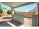 Enclosed backyard patio, featuring a concrete floor, stucco walls, and gated access to a landscaped area at 13416 W Ventura St, Surprise, AZ 85379