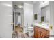 This bathroom features wood-look flooring, vanity with storage, and walk way at 13416 W Ventura St, Surprise, AZ 85379