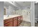 Well-lit bathroom offers an extended vanity, plenty of cabinet space, and walk in shower at 13416 W Ventura St, Surprise, AZ 85379