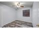 Neutral bedroom features a ceiling fan and wood-style flooring at 13416 W Ventura St, Surprise, AZ 85379