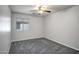 Neutral bedroom with carpet, a ceiling fan, and a window providing natural light at 13416 W Ventura St, Surprise, AZ 85379
