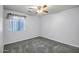 Comfortable bedroom featuring plush carpeting and a large window for ample natural light at 13416 W Ventura St, Surprise, AZ 85379