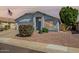 Charming single-story home featuring desert landscaping, covered entry, and an attached two-car garage at 13416 W Ventura St, Surprise, AZ 85379