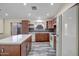 Bright kitchen with stainless steel appliances, a large island, and dark wood cabinetry at 13416 W Ventura St, Surprise, AZ 85379