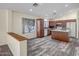 Open kitchen boasts a central island, wooden cabinets, recessed lighting, and modern appliances at 13416 W Ventura St, Surprise, AZ 85379
