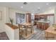 Charming kitchen with wood cabinets, stainless appliances, island, and adjacent dining area at 13416 W Ventura St, Surprise, AZ 85379