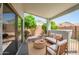 Inviting covered patio with comfortable seating and a view of the backyard at 13416 W Ventura St, Surprise, AZ 85379