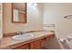 Bathroom featuring a wooden vanity, ceramic tile countertop and a large mirror at 14235 N 26Th Dr, Phoenix, AZ 85023
