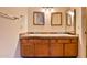 Bathroom featuring a double sink vanity with framed mirrors at 14235 N 26Th Dr, Phoenix, AZ 85023