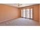 Bedroom featuring carpet flooring, a ceiling fan and french doors at 14235 N 26Th Dr, Phoenix, AZ 85023