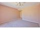 This carpeted bedroom features a ceiling fan and neutral wall colors at 14235 N 26Th Dr, Phoenix, AZ 85023