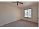 Neutral bedroom with carpet flooring, a ceiling fan and window with blinds at 14235 N 26Th Dr, Phoenix, AZ 85023