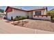 Charming single-story home with red trim, xeriscape landscaping, and a well-maintained lawn at 14235 N 26Th Dr, Phoenix, AZ 85023