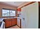 Kitchen area with stainless steel sink, white refrigerator, wood cabinets and tiled backsplash at 14235 N 26Th Dr, Phoenix, AZ 85023