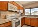 Functional kitchen with tile countertops, white appliances, and ample cabinet space at 14235 N 26Th Dr, Phoenix, AZ 85023