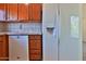Kitchen featuring a white refrigerator, white dishwasher and wood cabinets at 14235 N 26Th Dr, Phoenix, AZ 85023