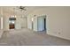 Open-concept living room with neutral carpet and easy access to the kitchen at 14235 N 26Th Dr, Phoenix, AZ 85023