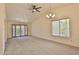 Spacious living room with neutral carpet, ceiling fan, and large windows with natural light at 14235 N 26Th Dr, Phoenix, AZ 85023