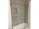 Bathroom features a shower and tub combination with neutral tiles and shower niche at 15225 N 100Th St # 1220, Scottsdale, AZ 85260