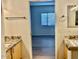 Bright bathroom with granite countertops, wood cabinets, and tile flooring at 15225 N 100Th St # 1220, Scottsdale, AZ 85260
